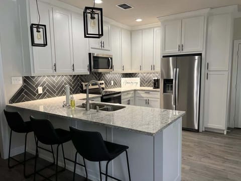 Light and airy fully stocked kitchen. 