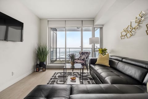 Bright and open living room space with sofa bed and balcony