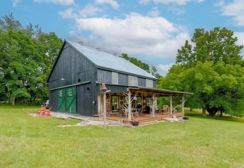 Barndominum with a beautiful large porch with comfortable space to relax and eat