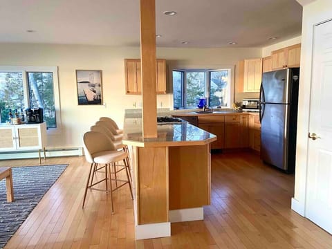 Kitchen and breakfast bar. Laundry/mud room conveniently located to the right off of kitchen through a closed door.