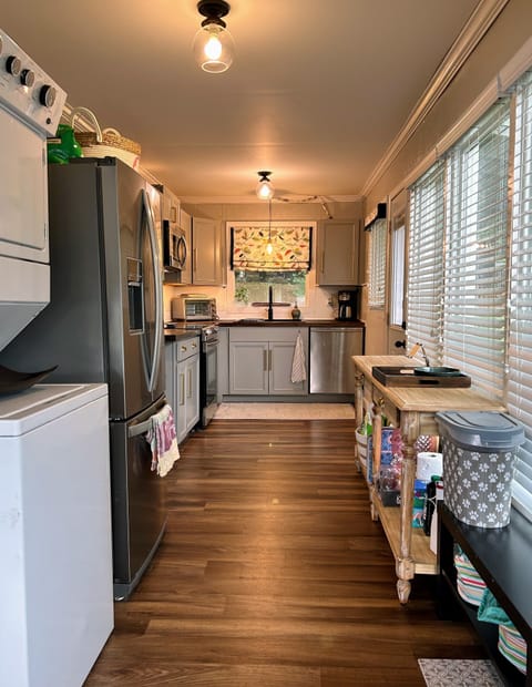 View of kitchen and stackable washer/dryer
