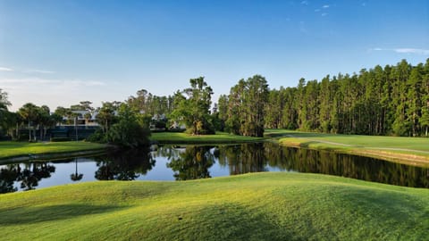 Tee off against a backdrop of shimmering lakes and rolling fairways.