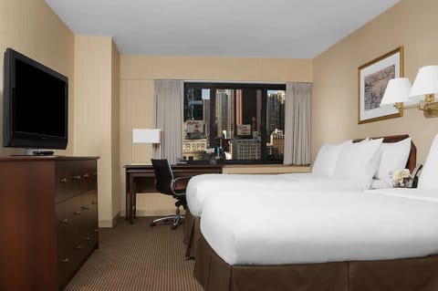 Unwind in crisp twin beds with inspiring city views.