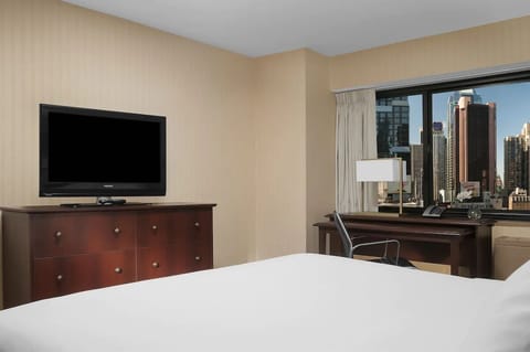 Kick back with bedside comfort, big TV, and a desk.
