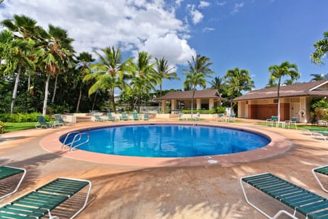 Resort-style community pool framed by swaying palms—perfect for refreshing swims and sunny afternoons.