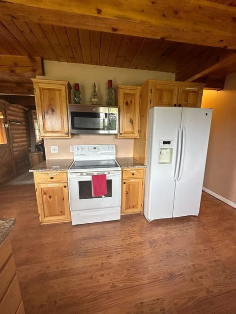 The kitchen has a full side-by-side fridge/freezer.