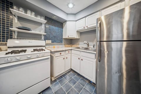 The full kitchen has lots of shelf space, with cabinets and open shelving.