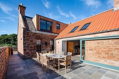 Papple Steading - Grieve's Cottage - terrace with outdoor seating for eight guests, accessed from the kitchen