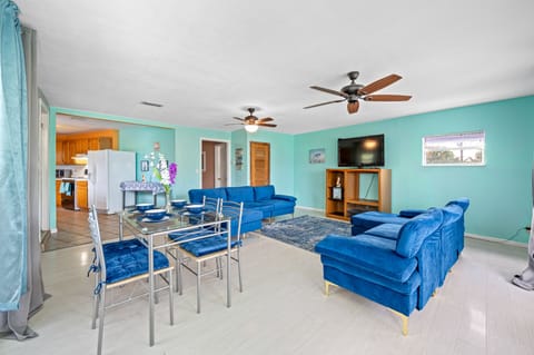 Living room, dining table, roku TV, 2 couches.