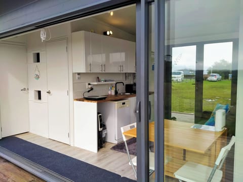 Kitchenette with temporarily unfolded dining table & chairs for meals/work.