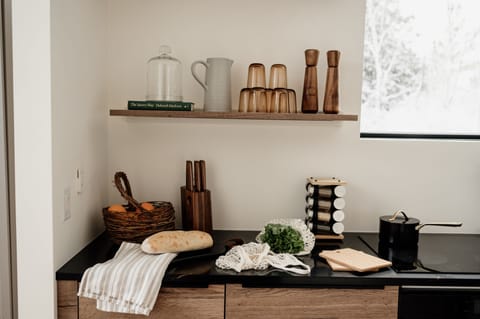 Open shelving and kitchen tells its own story while you gaze outdoors