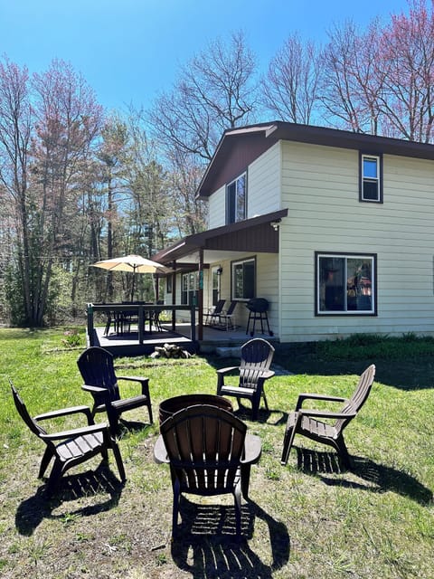 Side view of the house, Adirondack chairs/fire pit.