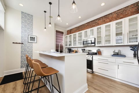 Dining and kitchen flow for easy entertaining, featuring a large island and bar seating.