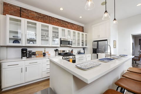 Fully stocked kitchen with stainless steel appliances for easy meal prep.