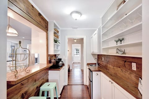 Rustic Coffee and Cocktail Bar – Beach Crew Cottage - This reclaimed wood bar is part coffee station, part cocktail corner—complete with a mini-fridge, sink, open shelving, and just the right touch of vacation flair. Whether it’s 8 a.m. espresso or 8 p.m. margaritas, this spot’s got you covered.