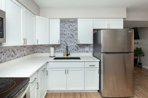 Brand new updated kitchen with quartz counters and SS appliances.