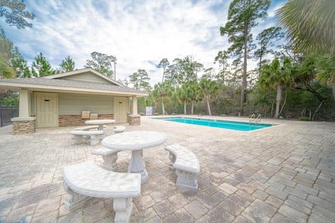 This community pool includes tables, lounge chairs and an on-site bathroom.