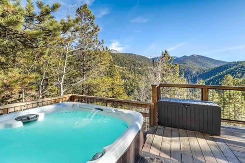 Relax in our scenic hot tub, basking in natural light and breathtaking views for an unforgettable experience.