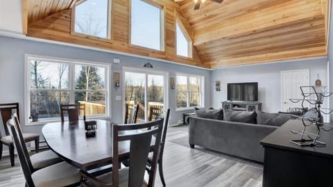 Bright Open-Concept Living Room with Vaulted Wood Ceilings
