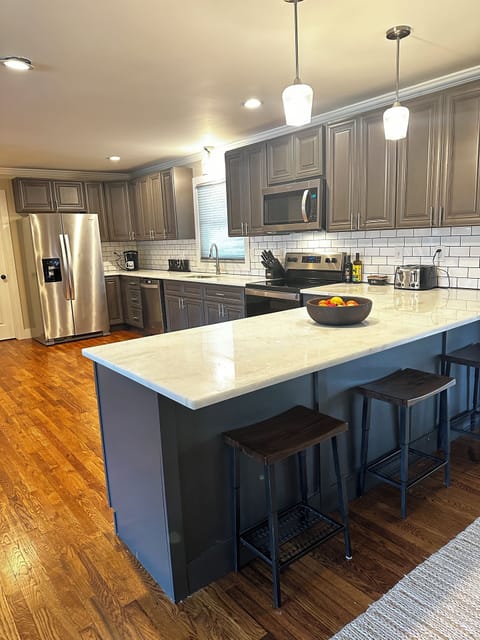 Large open kitchen with bar seating for 3