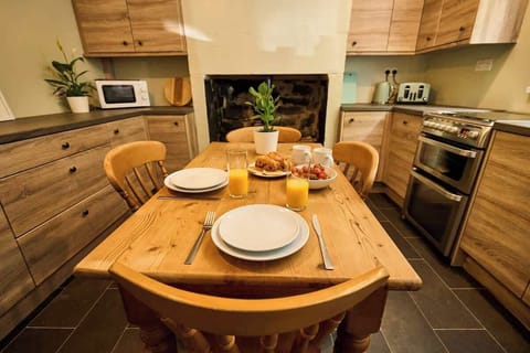 Start your day in a charming kitchen with a cozy dining setup and natural light.