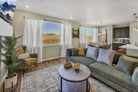 Living room with plush couch; area steps away from the kitchen and dining
