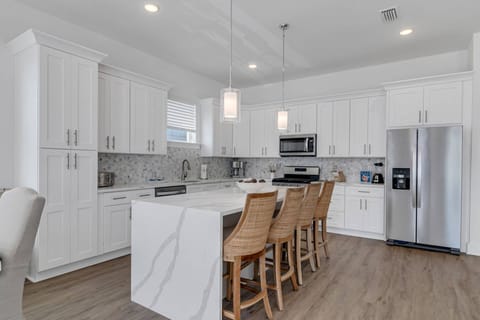 Well appointed open concept kitchen and dining area with seating for 12