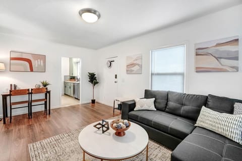 Embrace comfort in our welcoming living room, complete with a high-definition TV, a snug pull-out sofa, and a practical office desk for all your relaxation and work essentials.