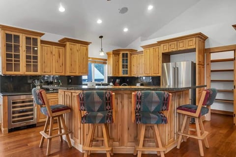 The kitchen boasts granite countertops and a spacious kitchen bar with four bar stools making it a great spot to grab a snack or relax while keeping the chef company.