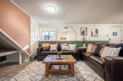 Warm and welcoming living room with plush seating, earthy tones, and the perfect setup for relaxing or streaming your favorite shows.

