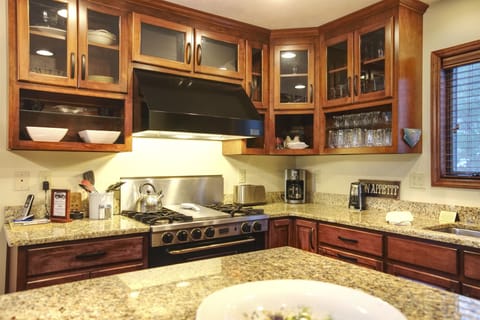 Closed and open cabinetry and granite countertops.