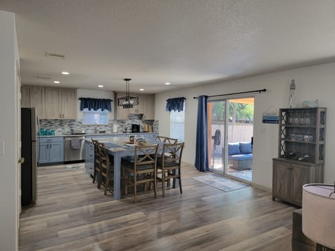 Sliding glass door to backyard seating and grilling area.