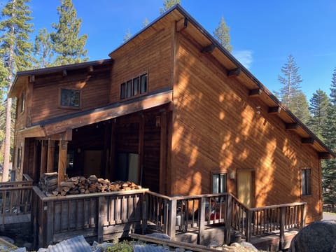 Multi level cabin with prized firewood pile.