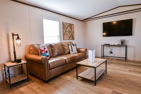 Comfortable leather couch and TV for relaxing.