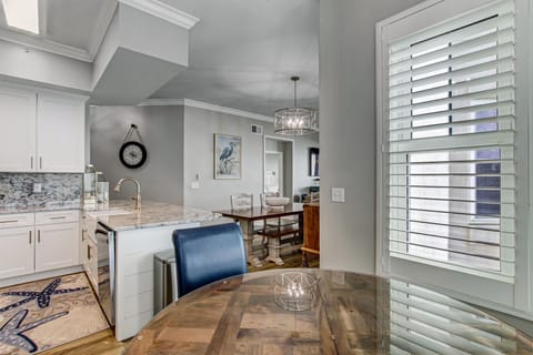 Fully Equipped Kitchen with Pristine White Cabinetry, Granite Countertops and Eat-In Table Space