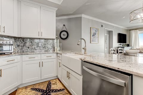 Fully Equipped Kitchen with Pristine White Cabinetry, Granite Countertops and Eat-In Table Space