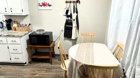 The cozy dining table offers a warm and inviting space for meals, perfect for enjoying a quiet dinner or gathering with loved ones. Its charming design creates a comfortable atmosphere for both casual meals and special occasions.