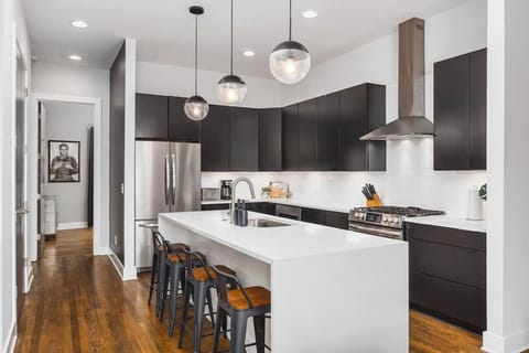 Fully-stocked chef's kitchen with a gas range, wet bar, seating for four at the island, and all the appliances / tools you could need to cook and enjoy a meal together.