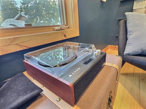 The sitting room's record player offers hours of musical enjoyment, providing a nostalgic touch to your relaxation time with an eclectic mix of records.