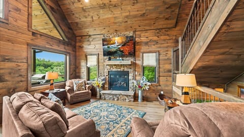 Watch TV from the comfortable sofa and two wide love seats surround the fireplace