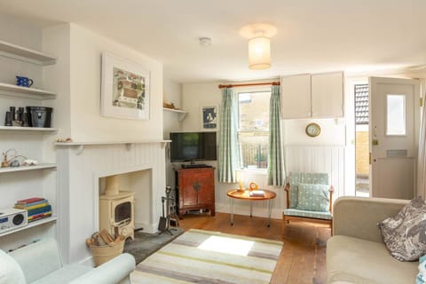 Open plan living room, dining room and kitchen with log burner.