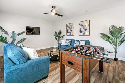 This vibrant game room, complete with a foosball table and comfortable seating, offers entertainment for all ages. Ideal for insurance relocations and long-term stays, it's conveniently located near local dining spots like Whataburger.