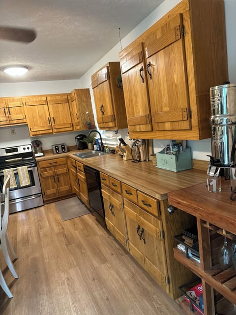 The kitchen is stocked with cookware and features a Breville juicer.