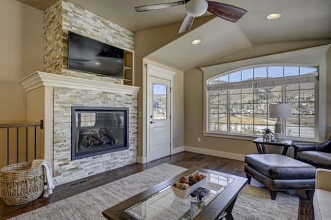 Living room with incredible views of the lake and mountain foothills!