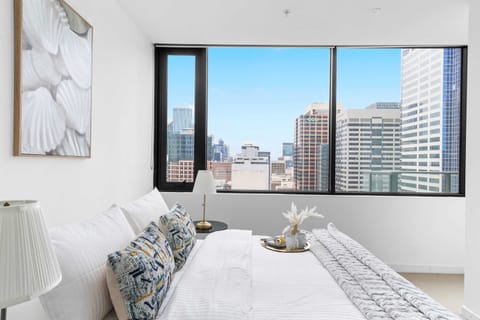 The master bedroom with a queen sized & plush pillows.