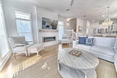 Relax in style with our sun-drenched living room that combines modern comfort with a touch of coastal elegance. Enjoy the designer furnishings, and the inviting open floor plan—perfect for your beach getaway!