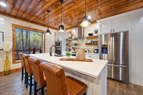 The kitchen also has views of the towering pines outside.