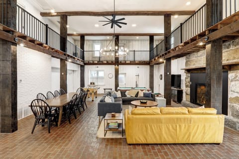 First floor with propane-fueled fireplace, game area, and large dining table