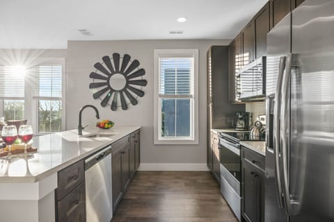 Fully equipped kitchen stocked with your basic cooking essentials, stainless steel appliances, and breakfast bar seating.