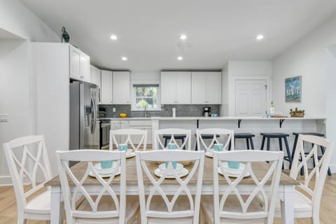 The dining room seats 8 people comfortably, with extra seating at the bar.